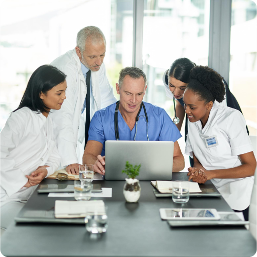Team of doctors reviewing material on a laptop